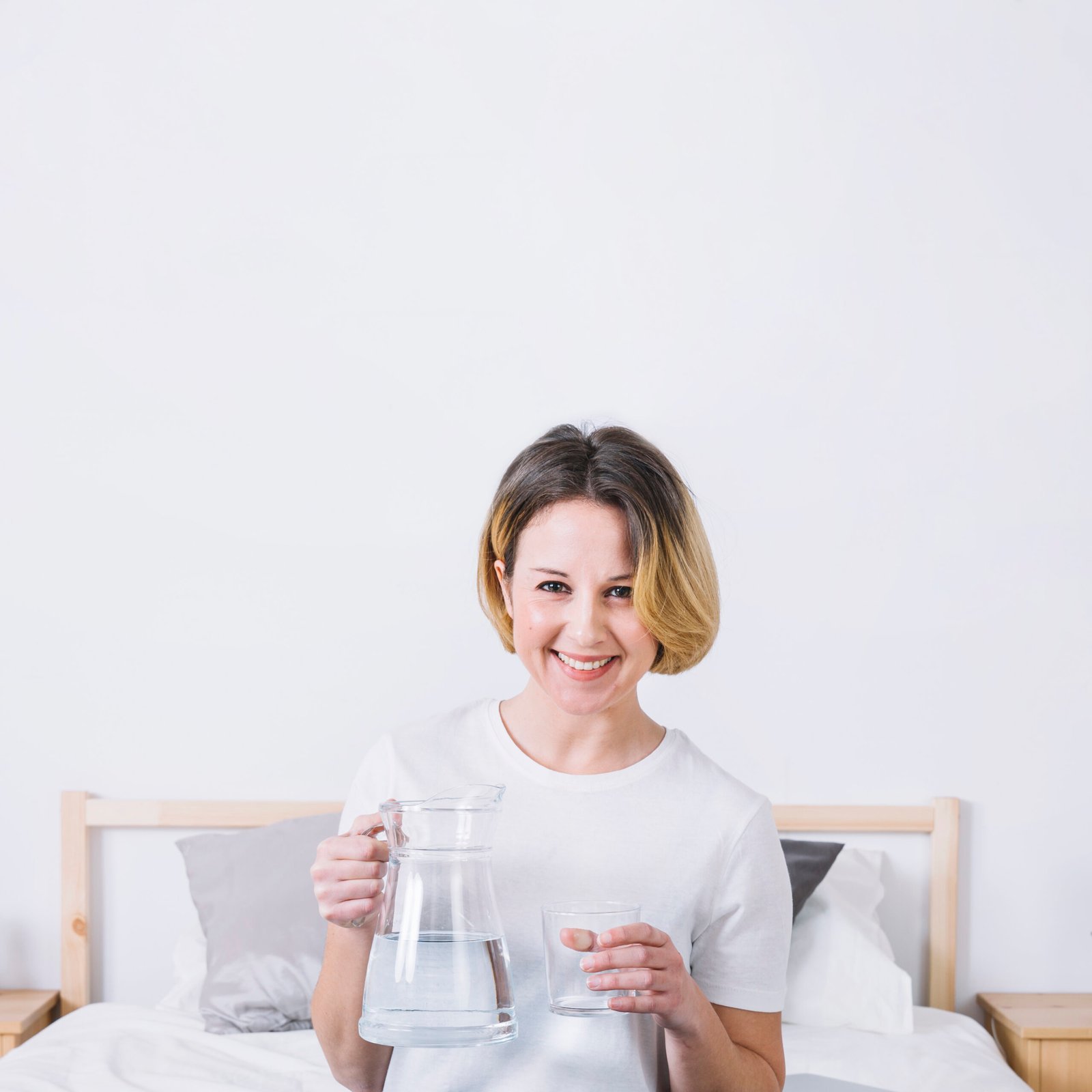 Home smiling woman with water posing bed